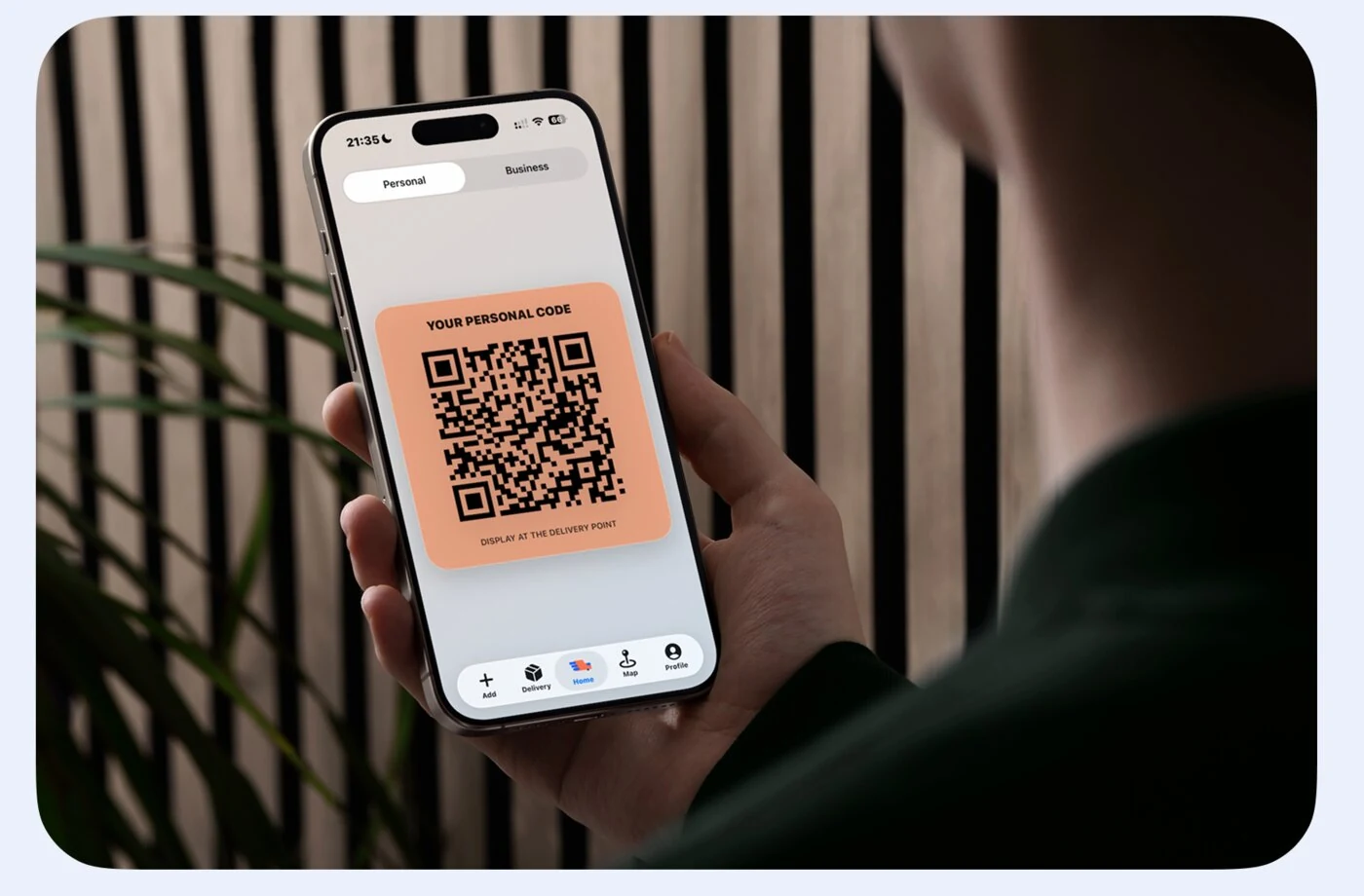 Hand holding a phone showing the Twist Express app QR code screen, 'Display at the delivery point.'