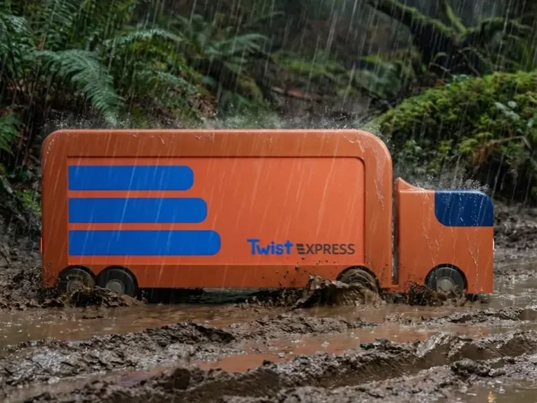 An orange Twist Express delivery vehicle crossing muddy terrain.